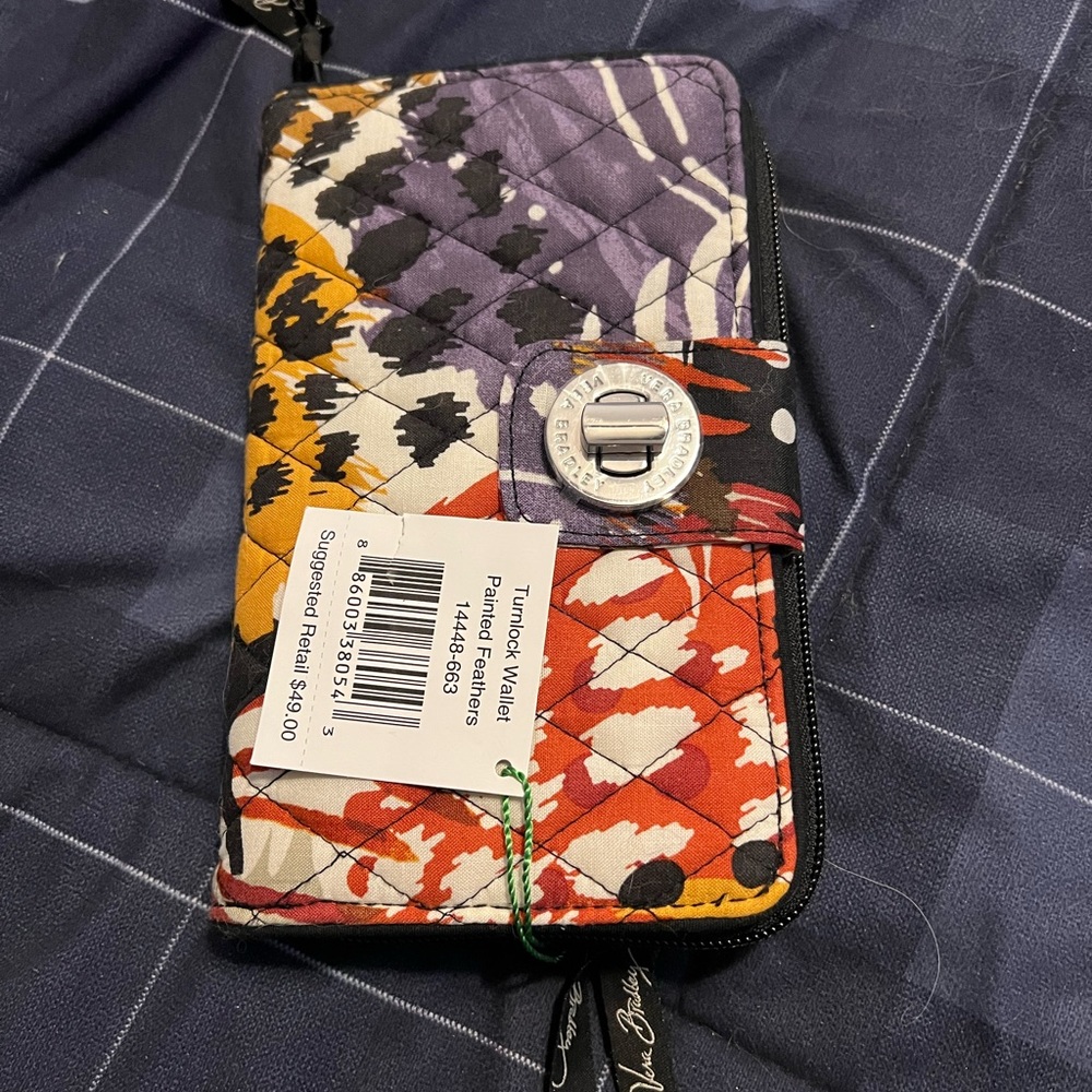 New with tags Vera Bradley Turnlock wallet in painted feathers print.